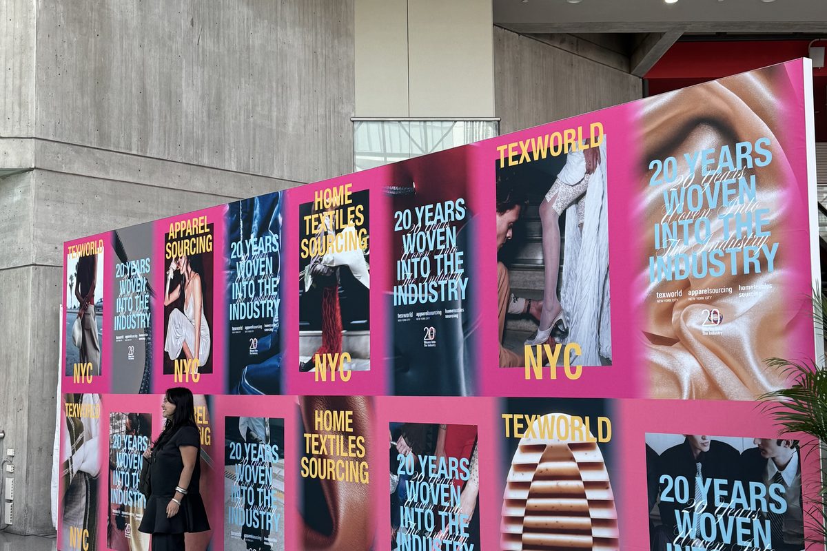 Texworld NYC 20th anniversary theme wall in pink reading 20 Years Woven Into the Industry.